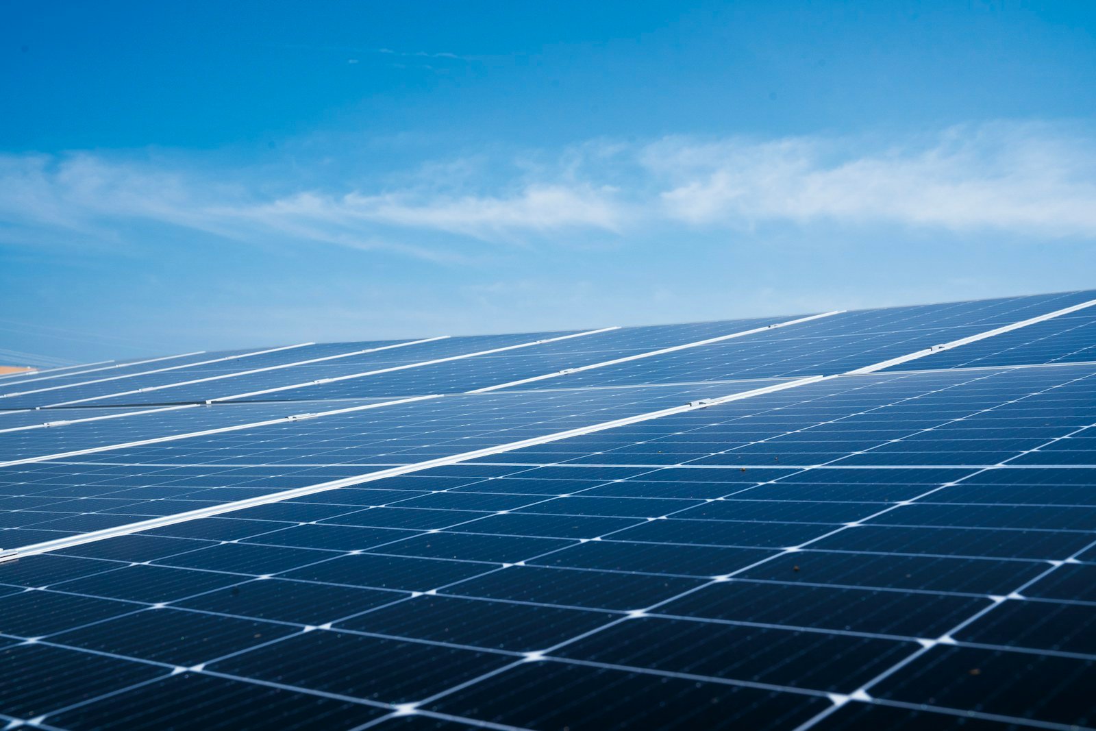 Photovoltaic panels beneath a blue sky
