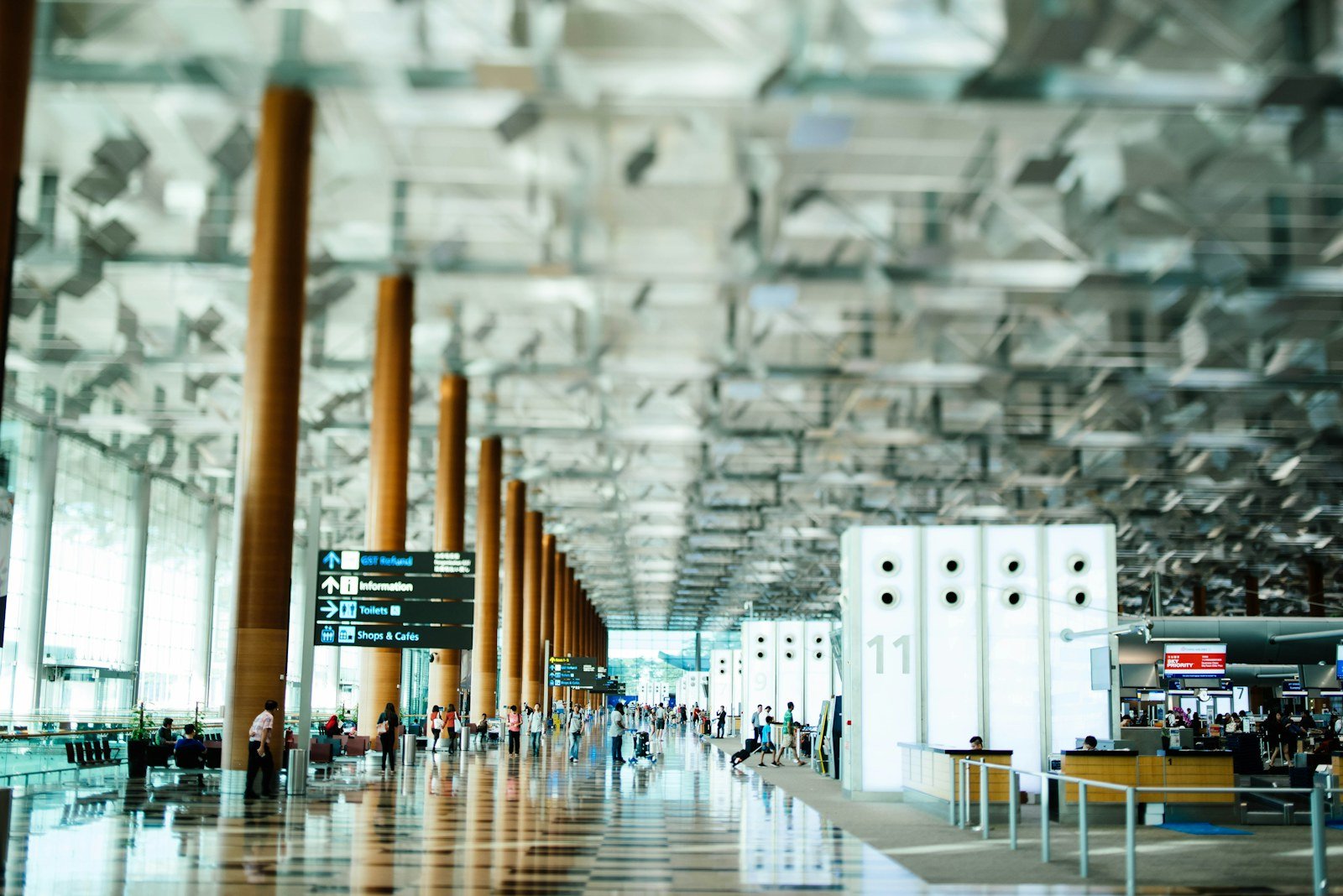 Terminal hall with check-in counters and wayfinding signs